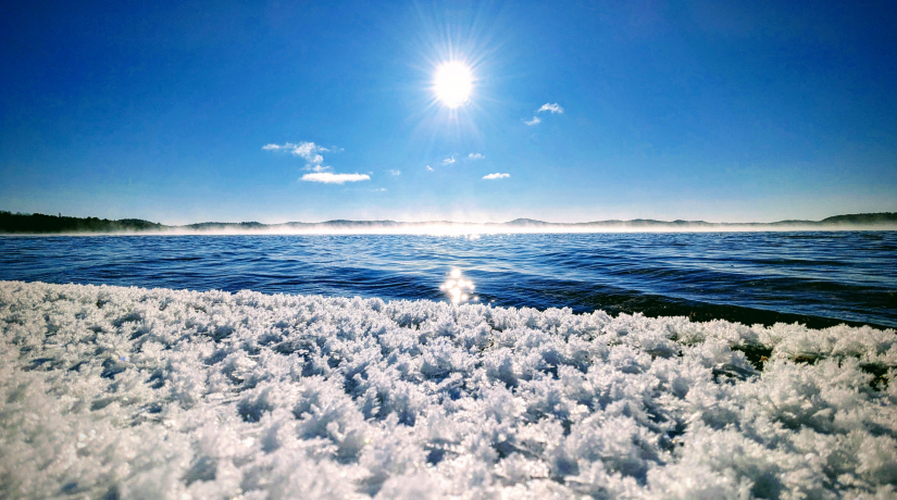 Windy Lake with snow crystals, fog and sun