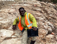MSc student Samuel Tetteh takes a break on a rock outcrop he is studying