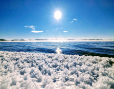 Windy Lake with snow crystals, fog and sun